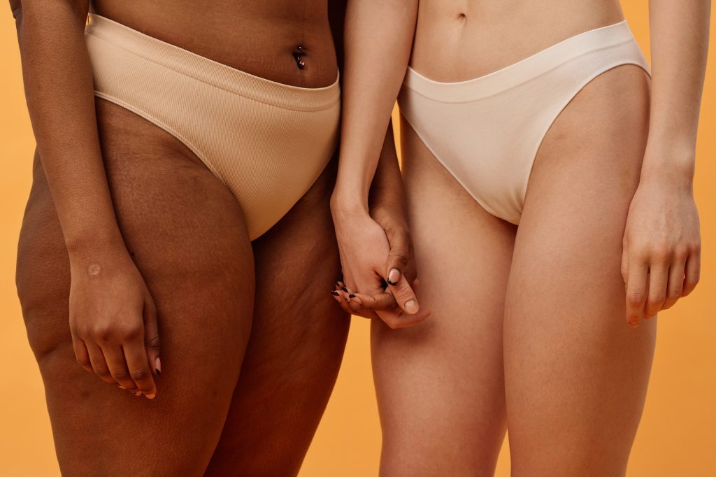 Unrecognizable Girls In Underwear Holding Hands