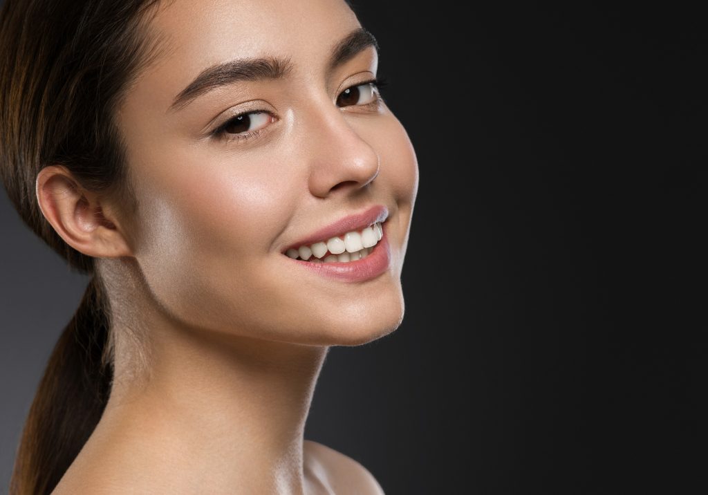 Beautiful smile woman with healthy tanned skin